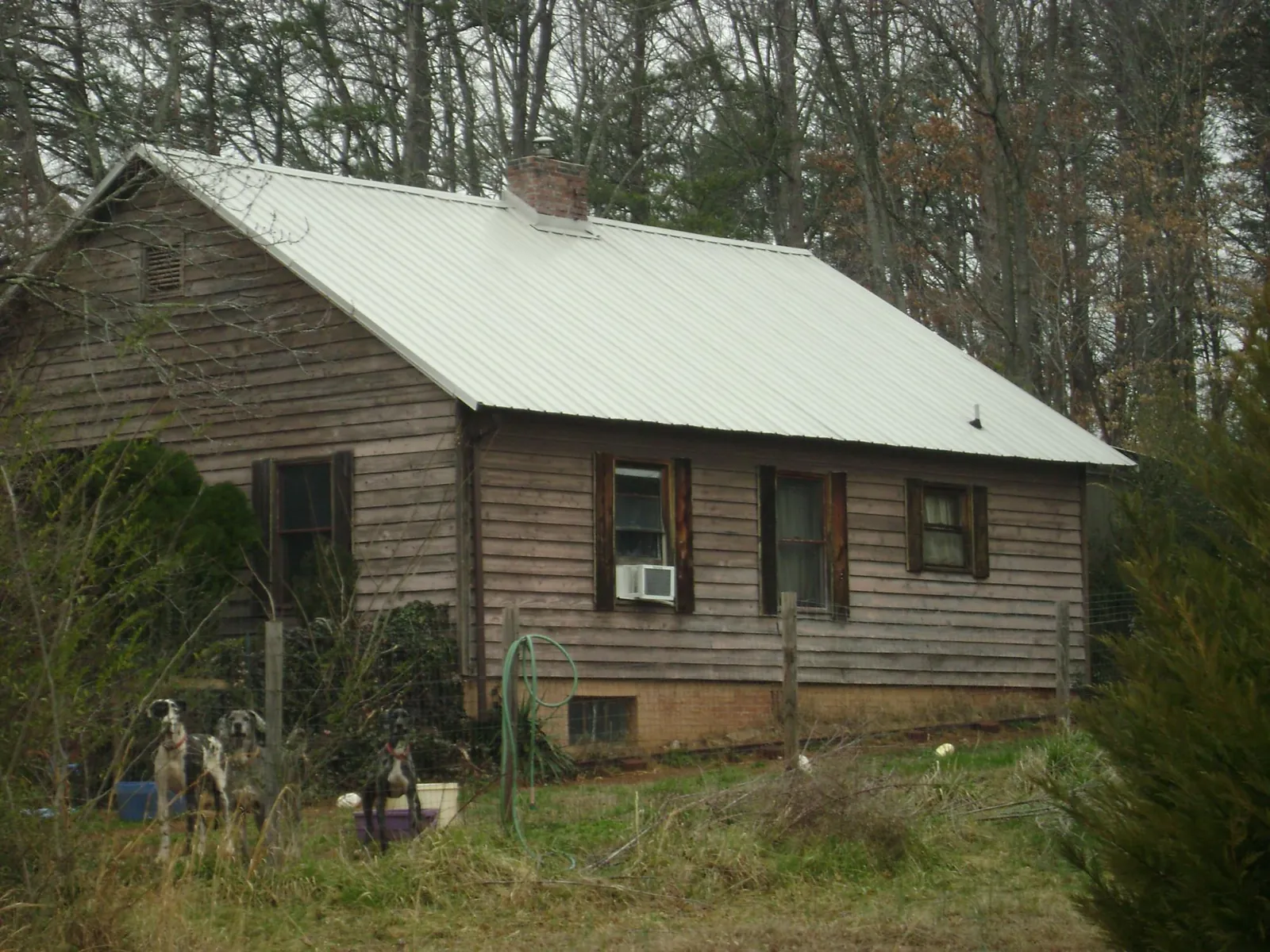 White metal roof on an old wood sided farmhouse, from a Metal Roof Installation job in Melrose